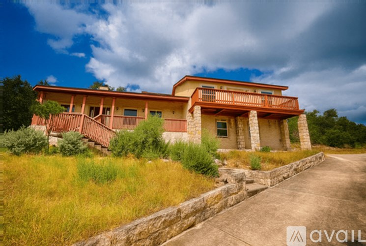 A house with a stone wall in front of it.