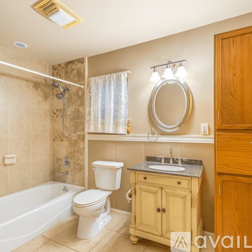 A bathroom with a toilet, sink, and bathtub.