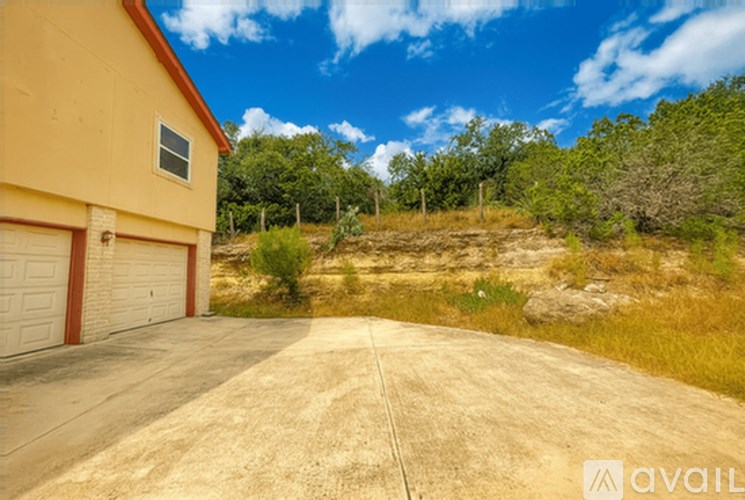 A house with a garage and a driveway in front of it.