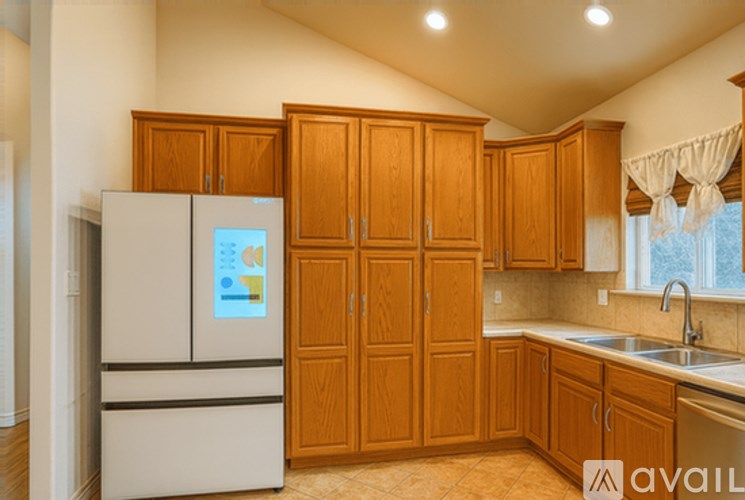 A kitchen with wooden cabinets and a white fridge.