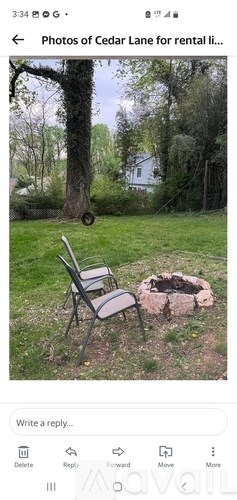A photo of a chair and a fire pit in a grassy area.