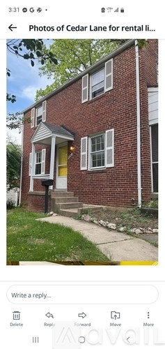 A red brick house with a yellow door and white window frames.