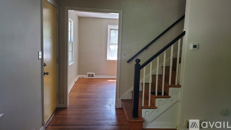 A hallway with a staircase leading to the second floor.