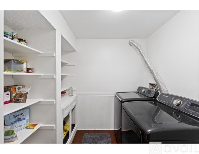 A small kitchen with a black dishwasher and a white fridge.