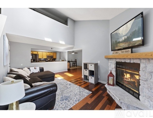 A modern living room with a fireplace and a television on the wall.