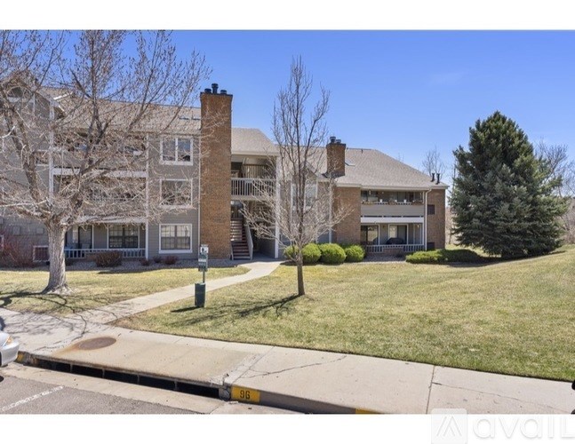 A building with a green lawn in front of it.