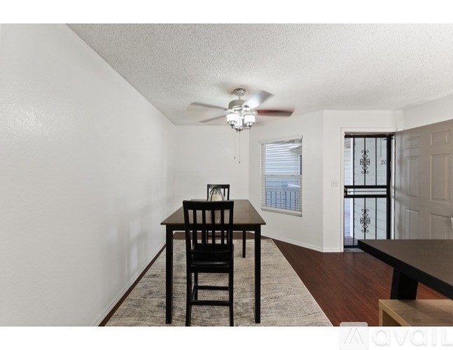 A dining room with a table and chairs.