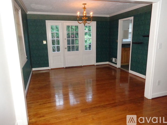 A room with wooden floors and green walls.