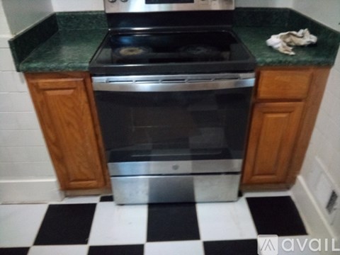 A kitchen with a black and white checkered floor.