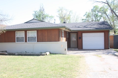 A brown house with a white garage door.