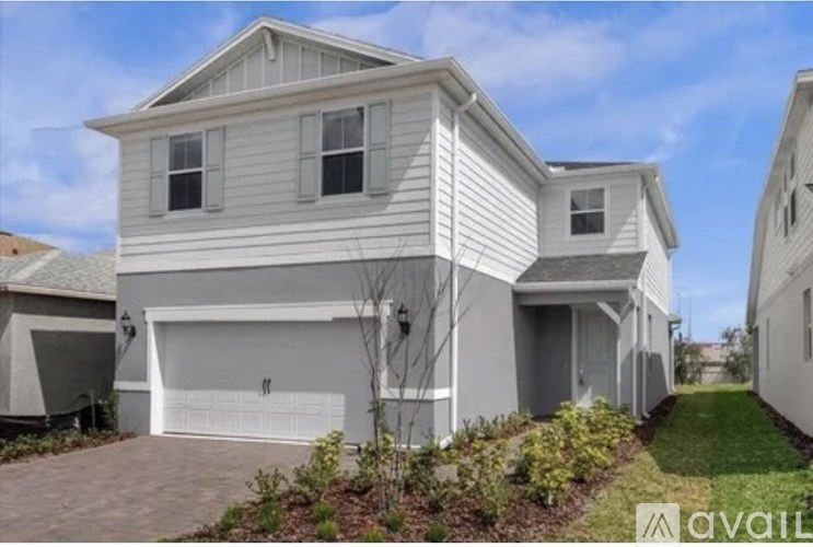 A two-story house with a garage is available for sale.