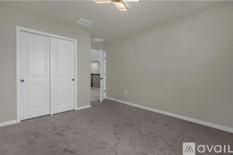 A room with two doors and a carpeted floor.