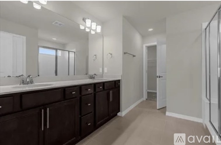 A bathroom with a vanity and a walk-in shower.