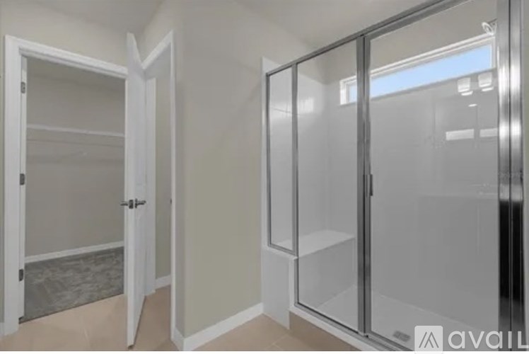 A room with a glass door and a white door.
