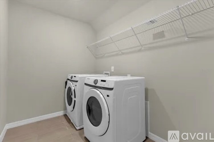 Two washing machines in a laundry room.