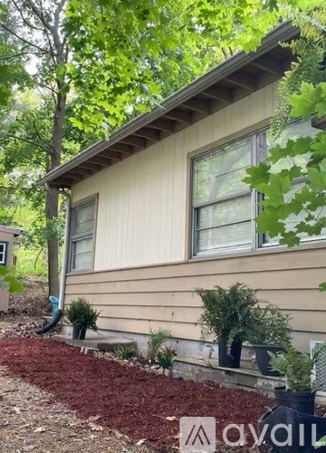 A house with a red mulch bed in front.