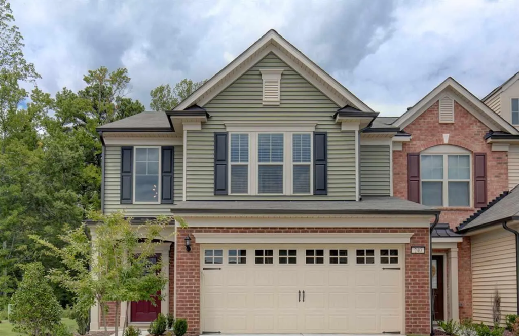 A two-story house with a garage door.