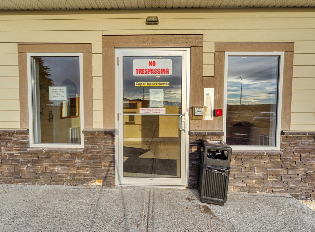 A building has a sign on the door that says "No Trespassing".