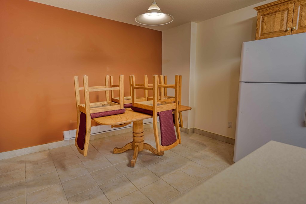 A room with a table and two chairs.