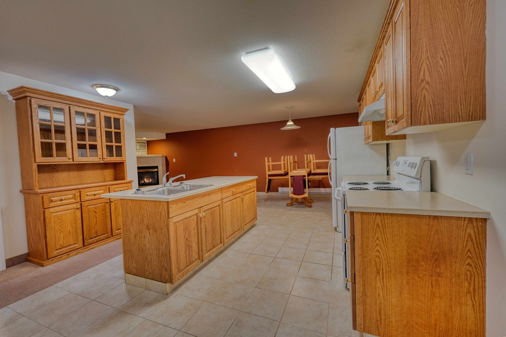 A kitchen with wooden cabinets and a white dishwasher.