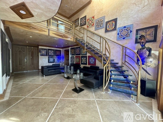 A living room with a staircase and a couch.