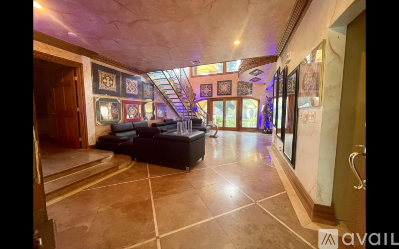 A spacious room with a staircase and a couch.