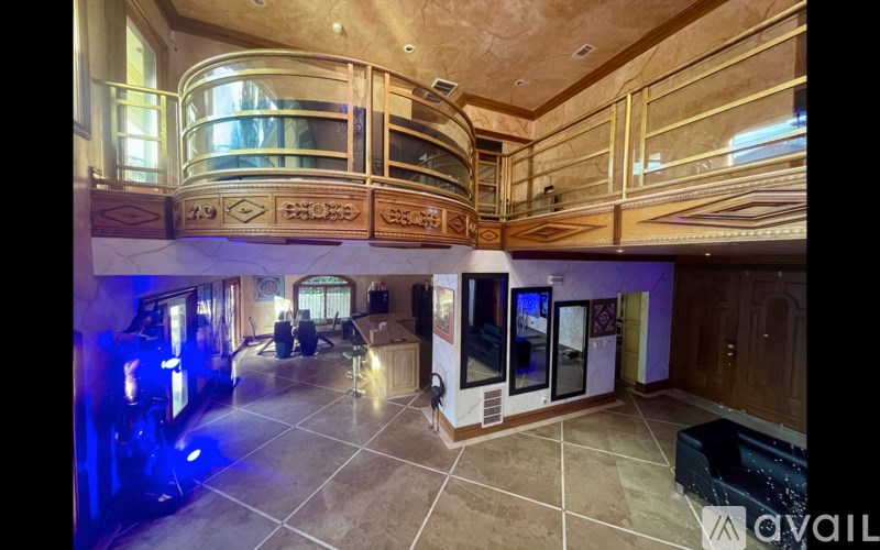 A luxurious room with a spiral staircase and a large mirror.