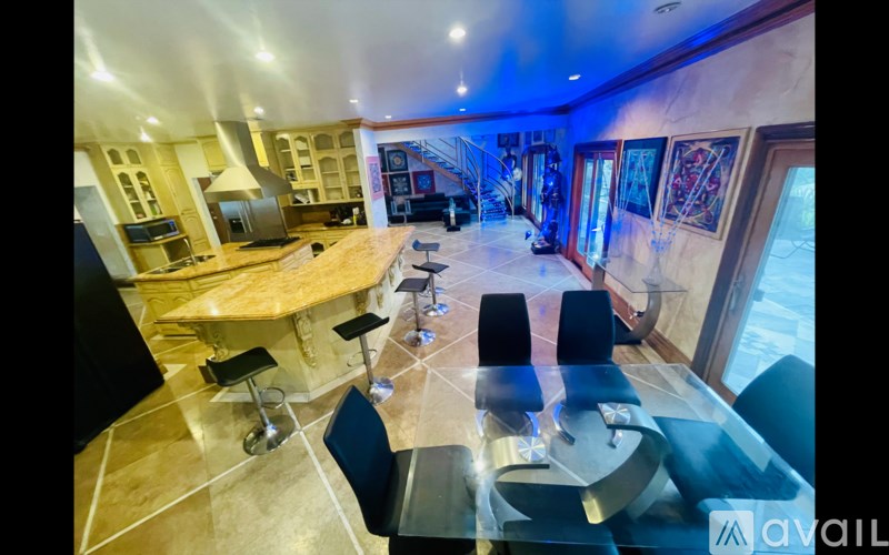 A modern kitchen with a dining area and a view of the outside.