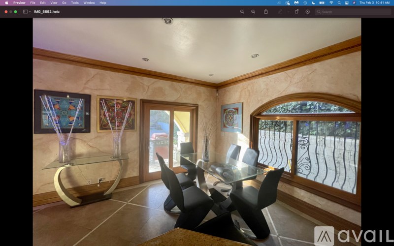 A dining room with a glass table and chairs.