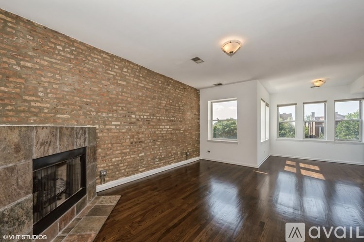 A room with a brick wall and wooden floors.