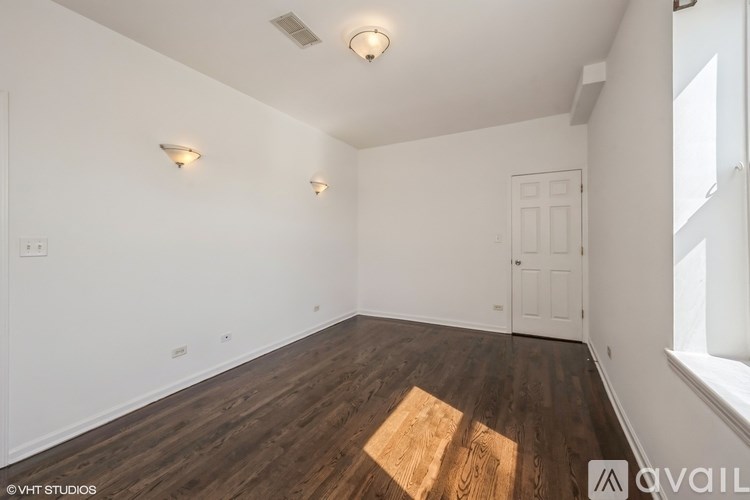 A room with wooden floors and white walls.