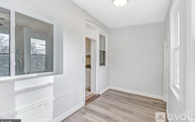 A room with white walls and a wooden floor.