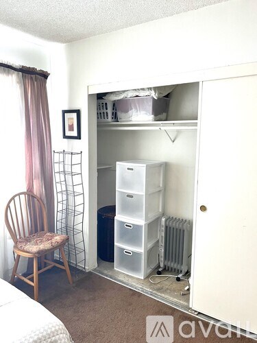 A white toilet sits next to a white sink in a bathroom.