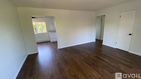 A room with wooden floors and white walls.