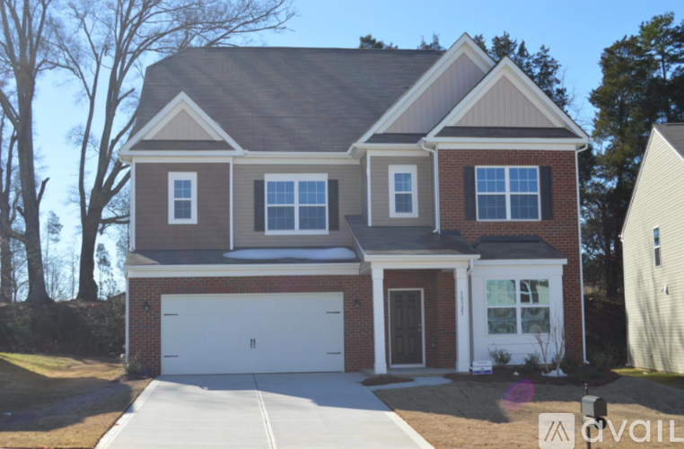 A two-story house with a garage is for sale.
