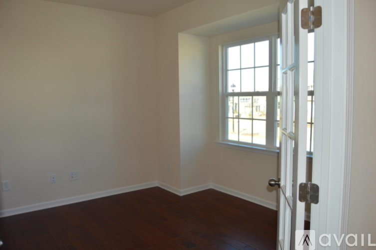 A room with a wooden floor and a window.