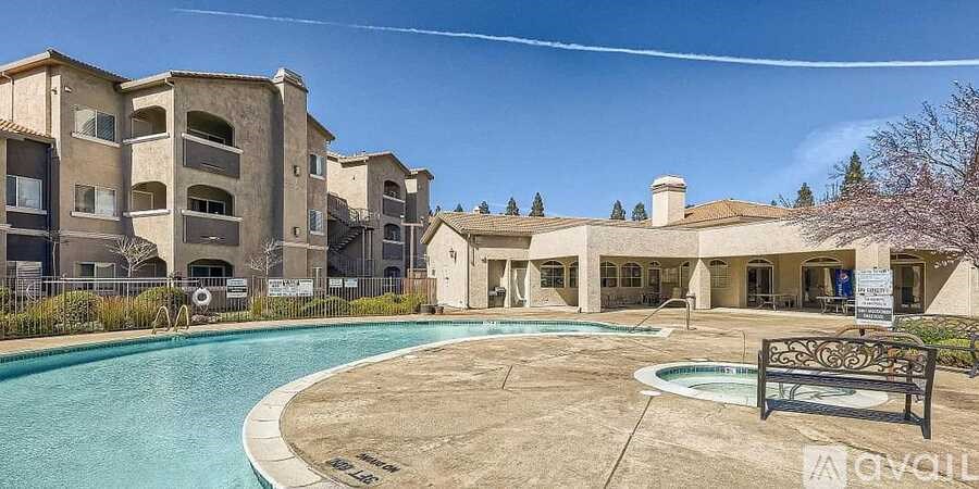 A large building with a pool in front of it.