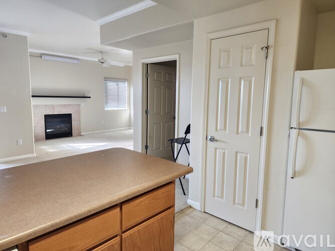 A kitchen with a white fridge and a white door.