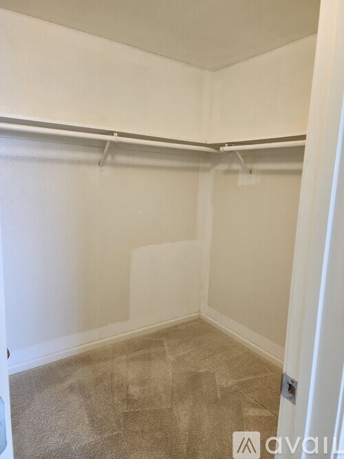 A room with white walls and a carpeted floor.