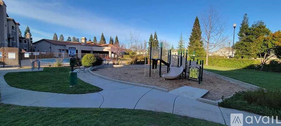 A playground with a slide, swings, and a climbing frame.