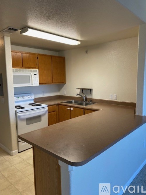 A kitchen with a countertop and a microwave above it.