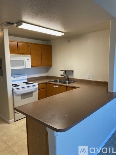 A kitchen with a countertop and a microwave above it.
