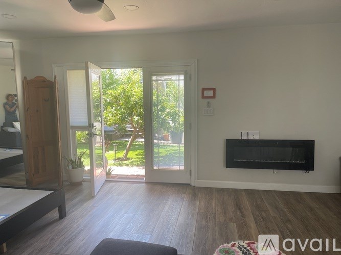 A living room with a television and sliding glass doors.