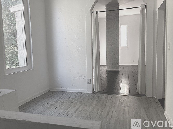 A room with a wooden floor and white walls.
