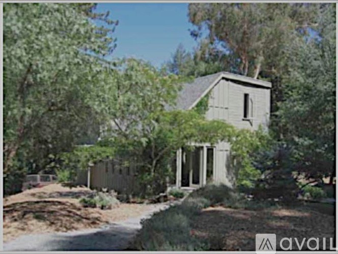 A house surrounded by trees and bushes.