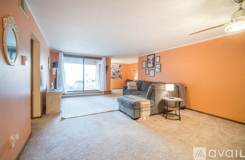 A living room with a grey sofa and a small table.