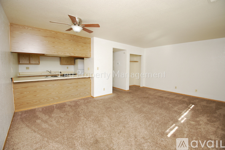 A kitchen with wooden cabinets and a black stove top oven.