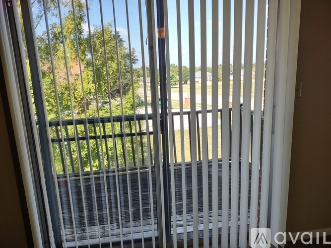 A view from a window with a metal grill.