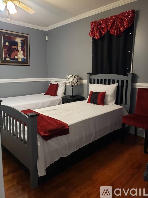 A bedroom with a bed, pillows, and a ceiling fan.