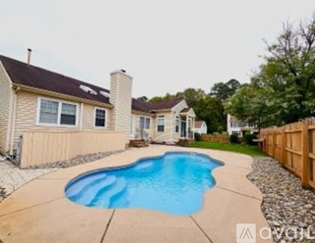 A bedroom with a bed covered in a quilt with a sports theme on it.